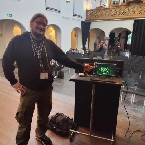 Roland Golla als Speaker mit seinem Laptop vor dem Publikum beim Talk über Cypress.IO Website Testing auf dem TYPO3 Camp Venlo 2023